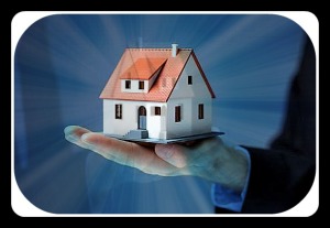 Businessman holding home model. Loan concept